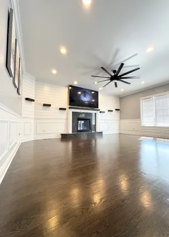a view of dining room with kitchen island stainless steel appliances wooden floor and window