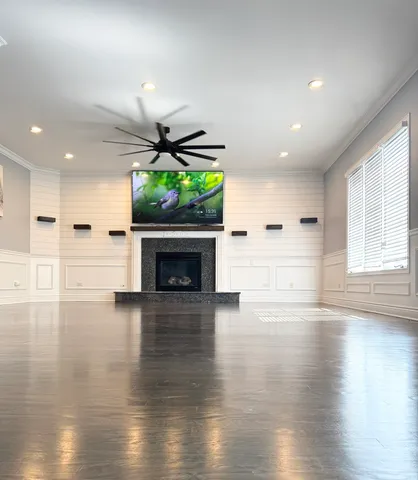 an empty room with wooden floor and a fireplace