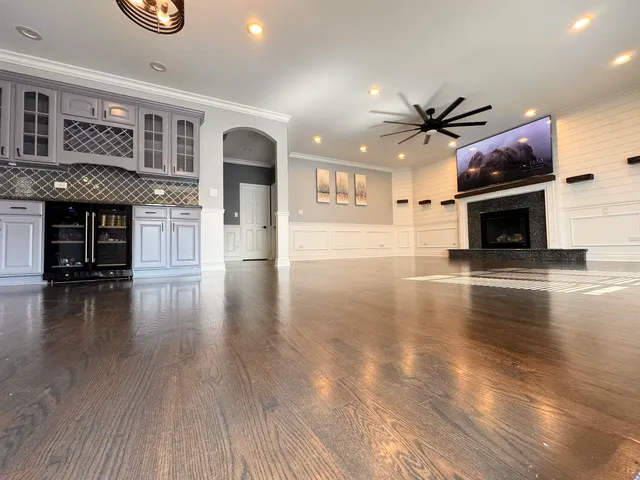 a view of a livingroom with fireplace and wooden floor