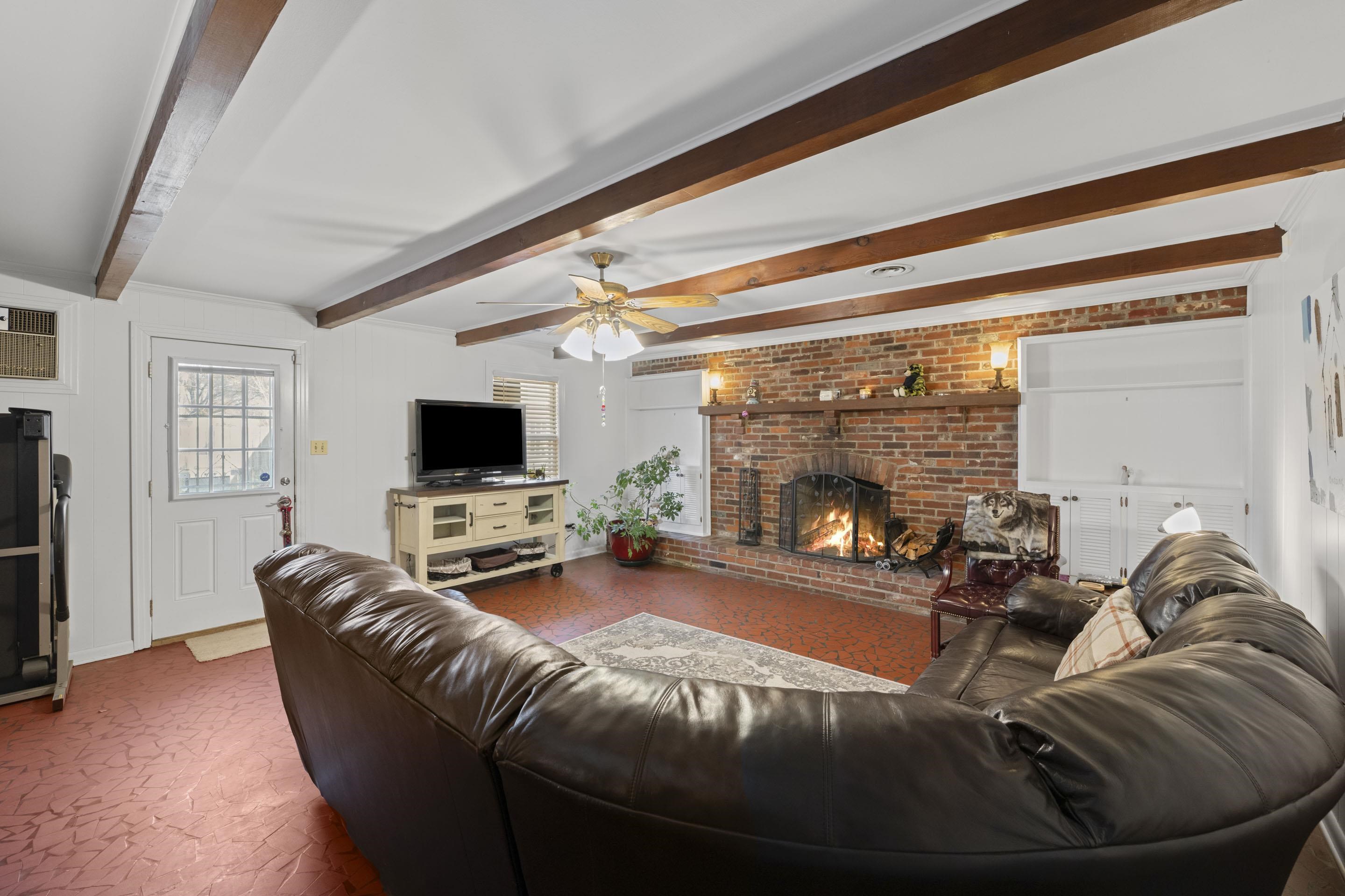 1694 South White Station Road Memphis, TN 38117 - Photo 11 of 26 This den offers room to spread out and unwind, with rustic charm and plenty of space for lounging and entertaining.