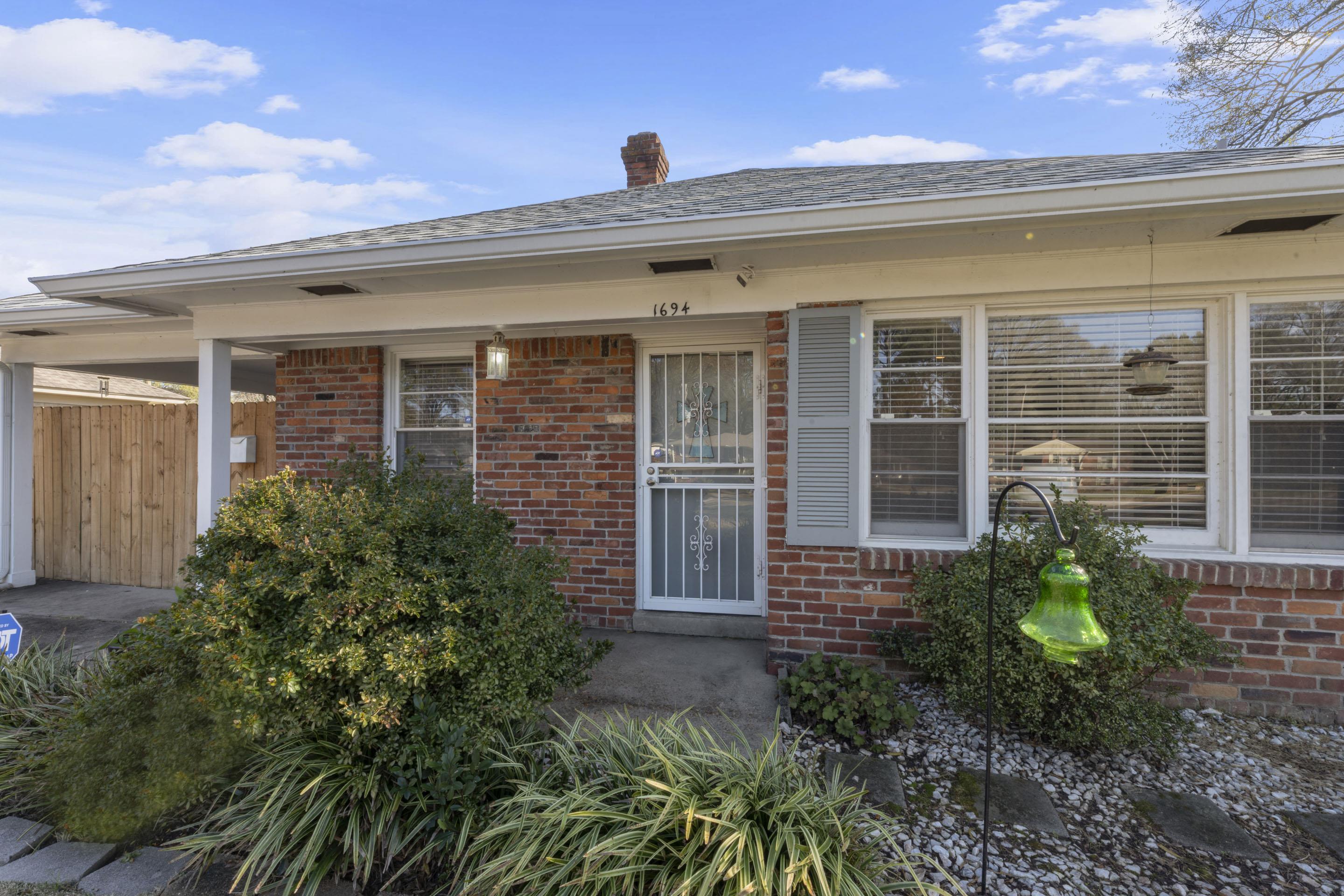1694 South White Station Road Memphis, TN 38117 - Photo 2 of 26 Step inside this inviting 3-bedroom, 1.5-bath home where comfort meets character. From original hardwood floors to the cozy den with wood-burning fireplace, this home offers a perfect balance of charm, modern updates, and easy living.