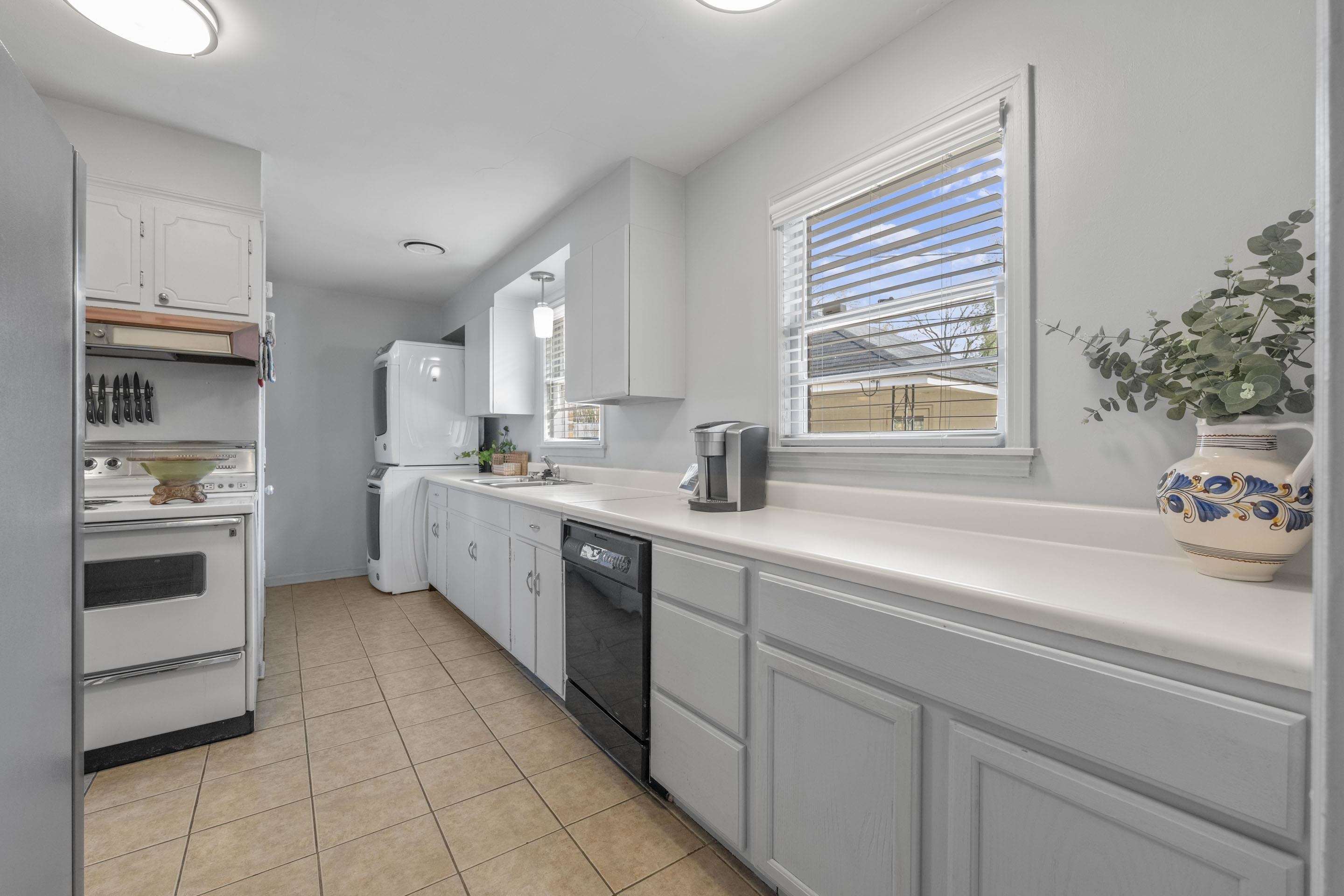 1694 South White Station Road Memphis, TN 38117 - Photo 9 of 26 The kitchen features the original electric stove, durable layout, and easy access to the dining room.