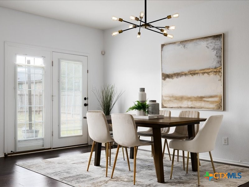 18817 Star Gazer Way Pflugerville, TX 78660 - Photo 13 of 36 a view of a dining room with furniture window and wooden floor