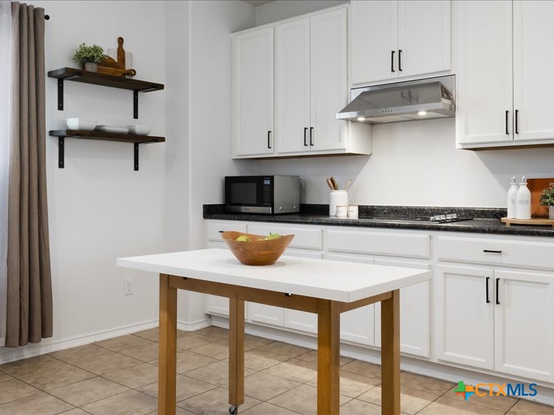 18817 Star Gazer Way Pflugerville, TX 78660 - Photo 17 of 36 a kitchen with stainless steel appliances cabinets and wooden floor