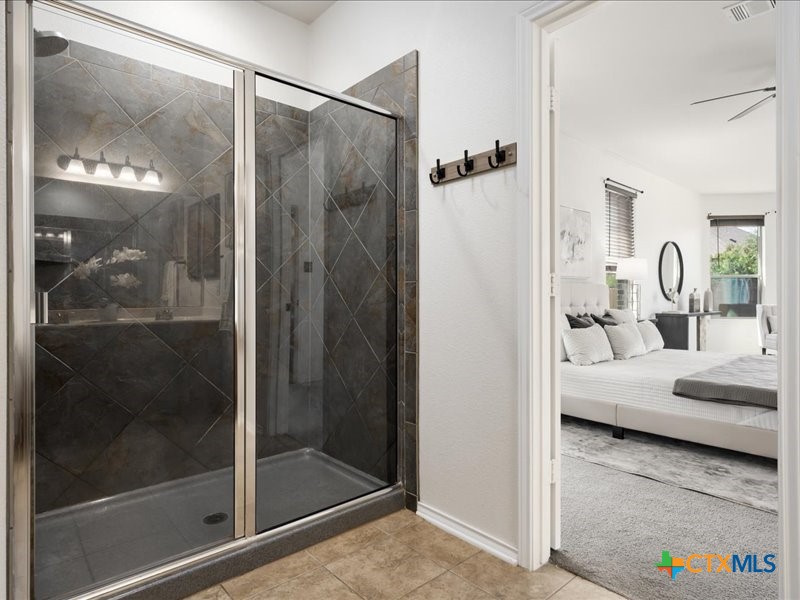 18817 Star Gazer Way Pflugerville, TX 78660 - Photo 23 of 36 a bathroom with a shower and a sink