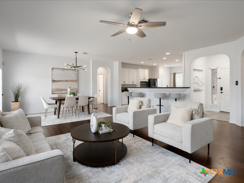 18817 Star Gazer Way Pflugerville, TX 78660 - Photo 3 of 36 a living room with furniture kitchen view and a chandelier