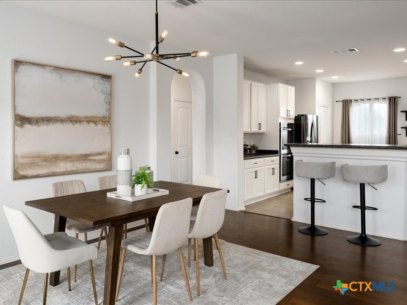 18817 Star Gazer Way Pflugerville, TX 78660 - Photo 4 of 36 a view of a dining room with furniture and a window