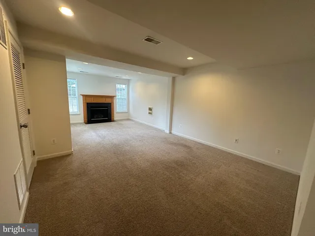 a view of an empty room with a fireplace