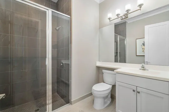 a bathroom with a toilet a sink a mirror and vanity