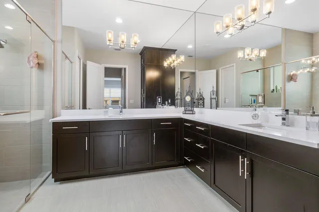 a bathroom with a sink vanity and a large mirror