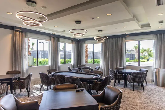 a view of a dining room with furniture wooden floor and chandelier