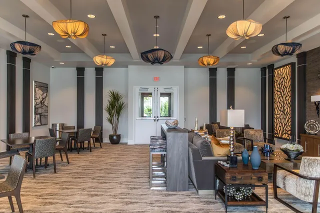 a view of a dining room with furniture and chandelier