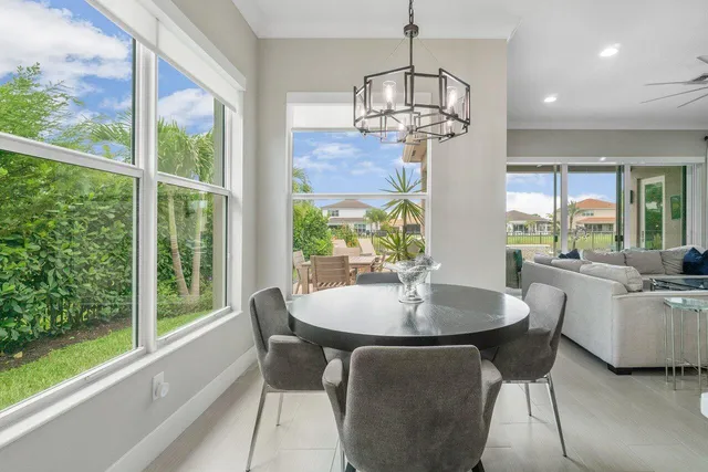 a view of a dining room with furniture wooden floor and chandelier