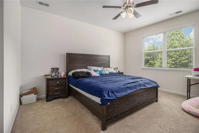 a bedroom with a bed and window