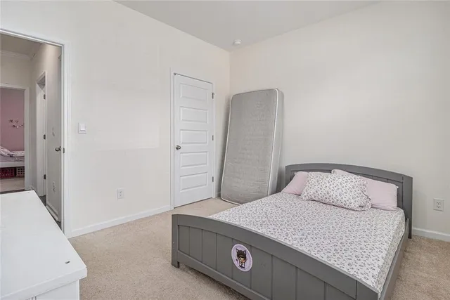 a bedroom with a bed and a mirror