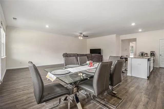 a view of a dining room with furniture and wooden floor