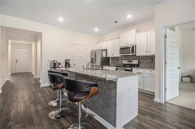 a kitchen with sink cabinets and wooden floor