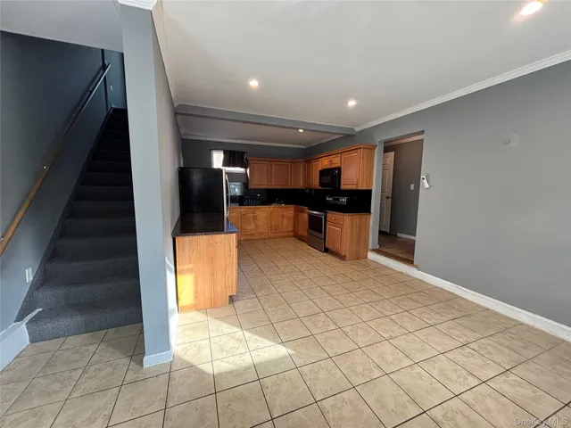 a kitchen with stainless steel appliances a refrigerator sink and microwave