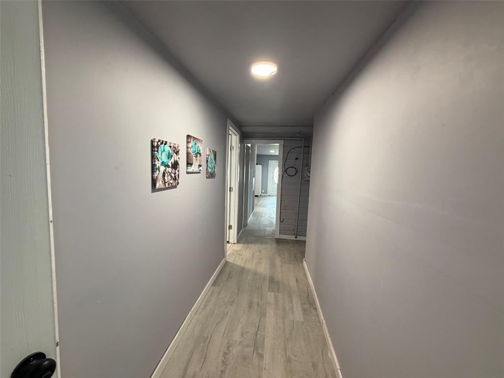 714 Southwest Dallas Street Grand Prairie, TX 75051 - Photo 22 of 27 Hallway featuring light gray walls, wood-finish flooring, and recessed ceiling lighting