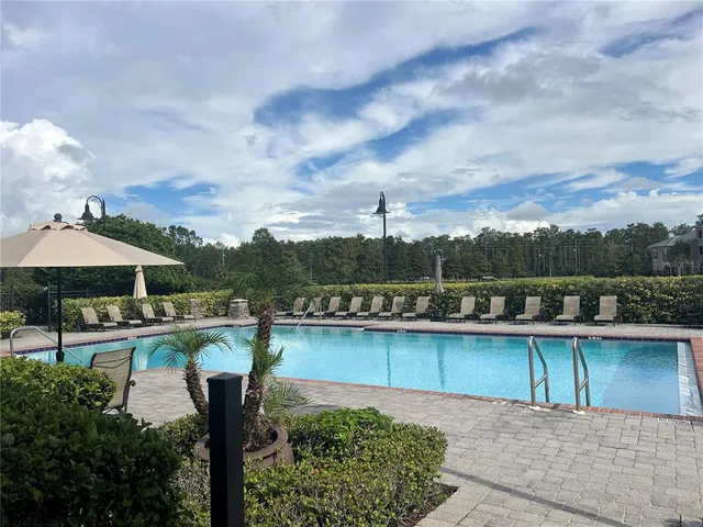 a view of a lake with a table and chairs