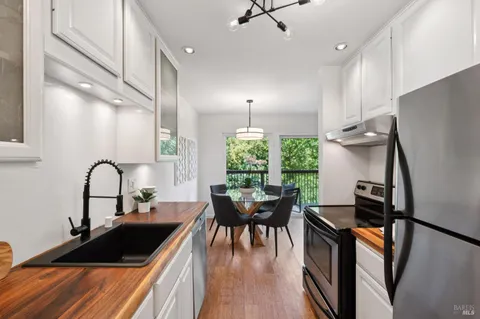 a kitchen with a table chairs and a stove