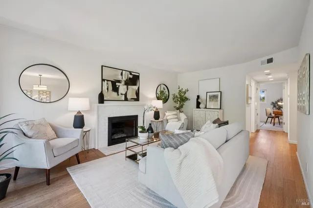 a living room with furniture a fireplace and a table