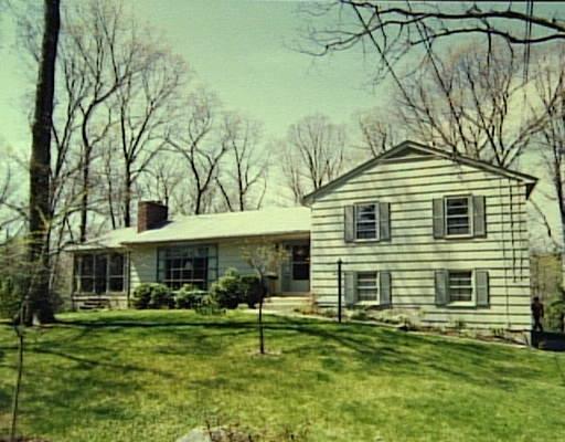 87 Sawmill Road Stamford, CT 06903 - Photo 1 of 1 a front view of a house with a garden
