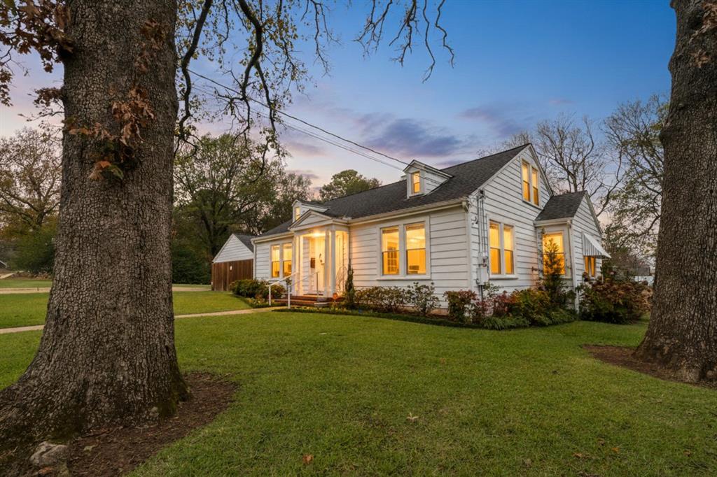 2257 Cleveland Street Paris, TX 75460 - Photo 2 of 28 a front view of a house with a garden