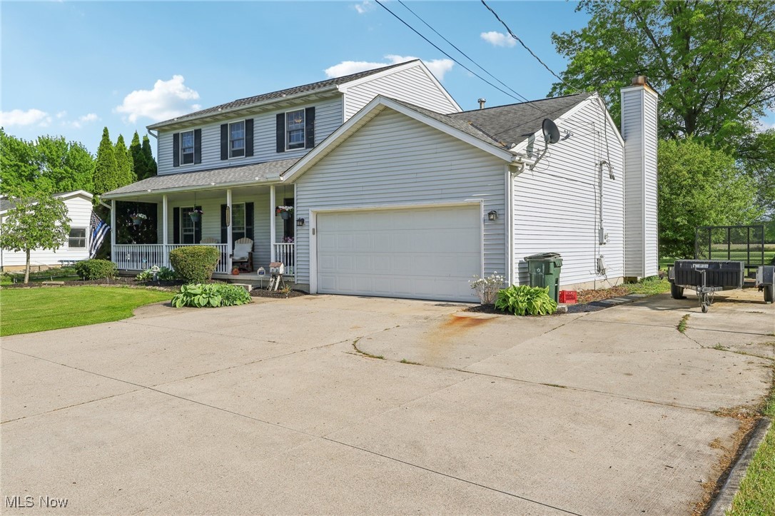 41553 Parsons Road Lagrange, OH 44050 - Photo 2 of 50 Traditional-style home with covered porch, an attached garage, driveway, and a chimney