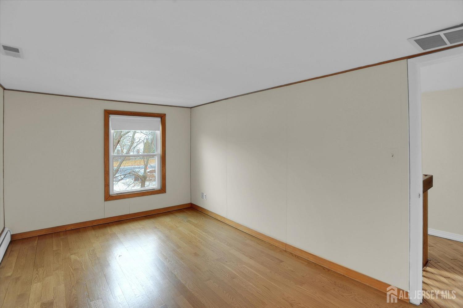 434 Ridge Road Dayton, NJ 08810 - Photo 27 of 46 a view of an empty room with wooden floor and a window