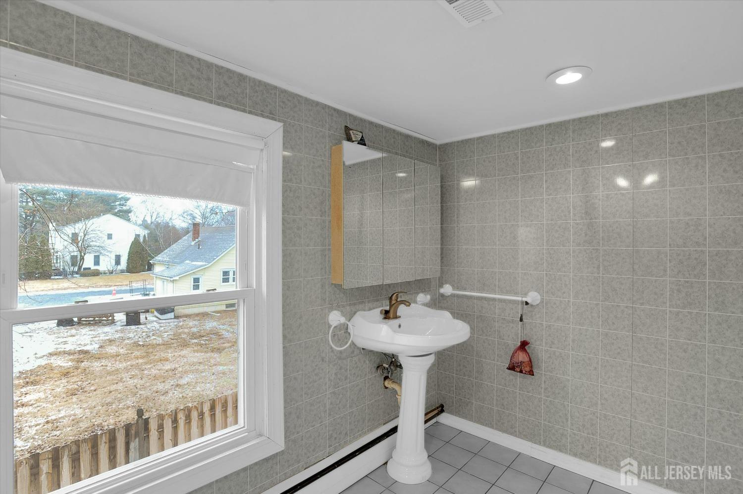 434 Ridge Road Dayton, NJ 08810 - Photo 31 of 46 a bathroom with a sink mirror and glass door