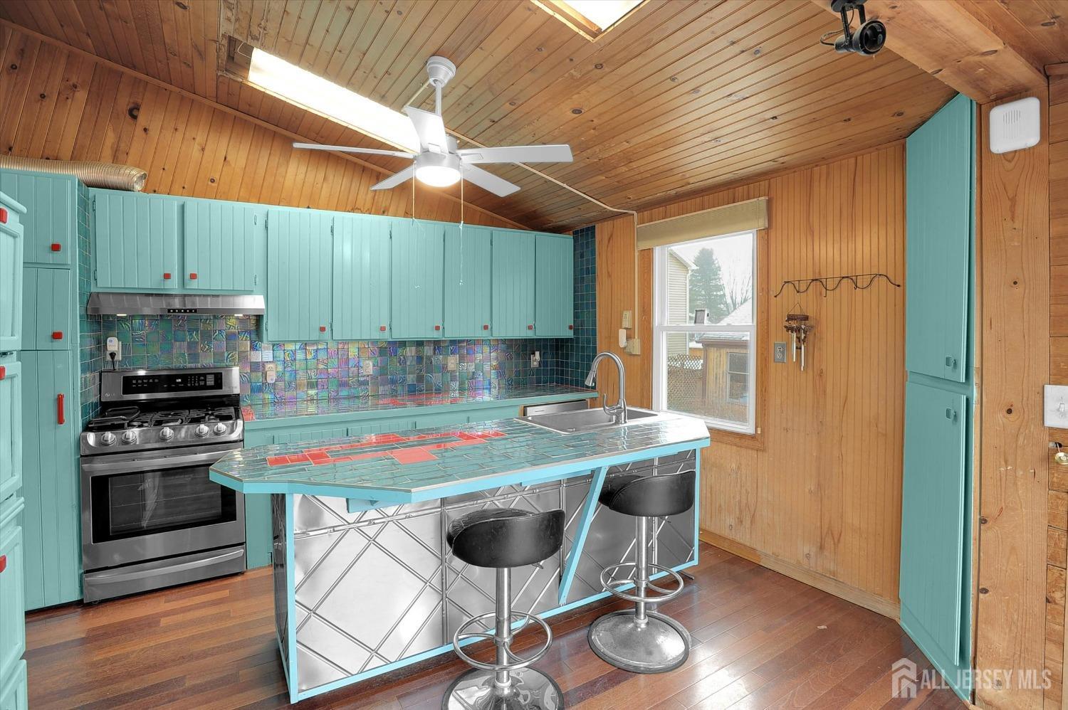 434 Ridge Road Dayton, NJ 08810 - Photo 9 of 46 a kitchen with kitchen island a table and chairs in it