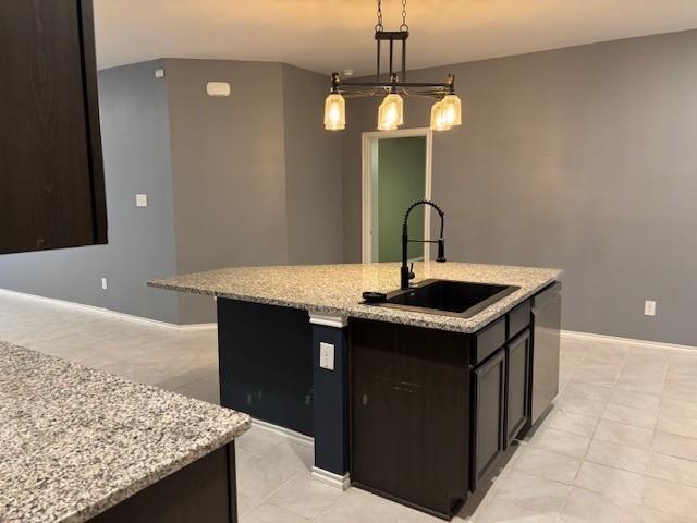 515 Rustic Meadows Trail Princeton, TX 75407 - Photo 6 of 29 a kitchen with a sink a counter space and a chandelier