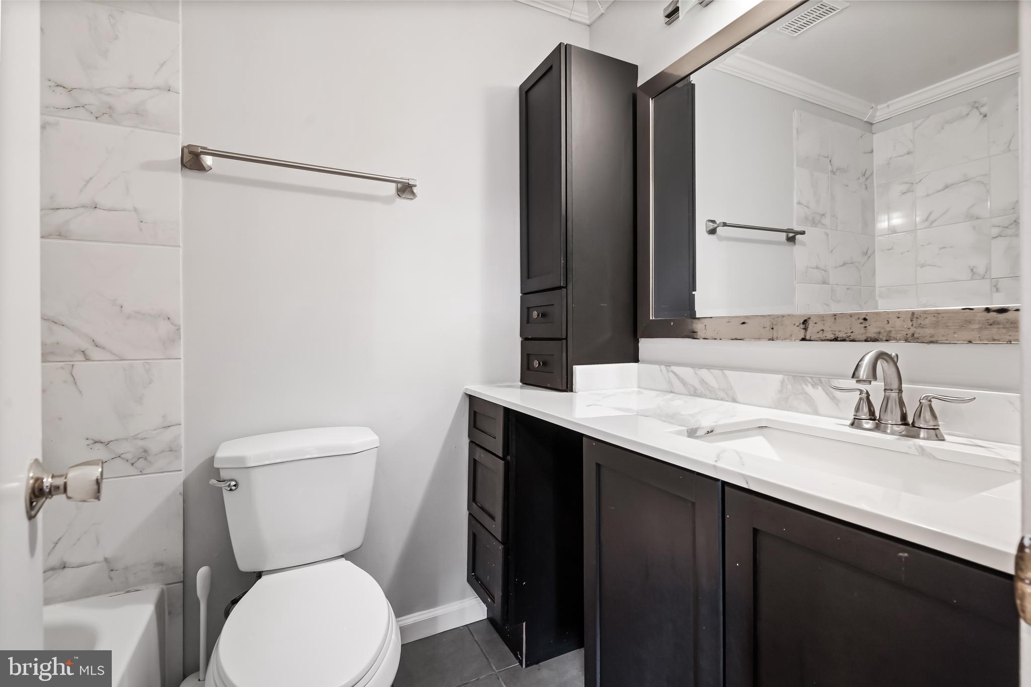 10322 Castlehedge Terrace Silver Spring, MD 20902 - Photo 15 of 25 a bathroom with a toilet sink and mirror