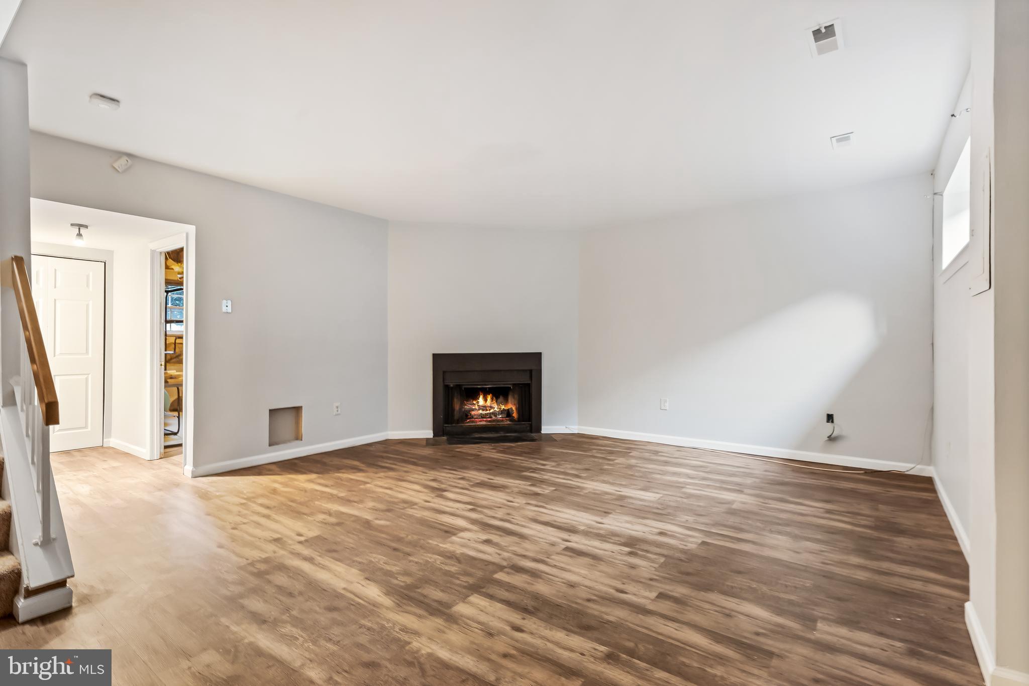 10322 Castlehedge Terrace Silver Spring, MD 20902 - Photo 20 of 25 a view of an empty room with wooden floor and a window