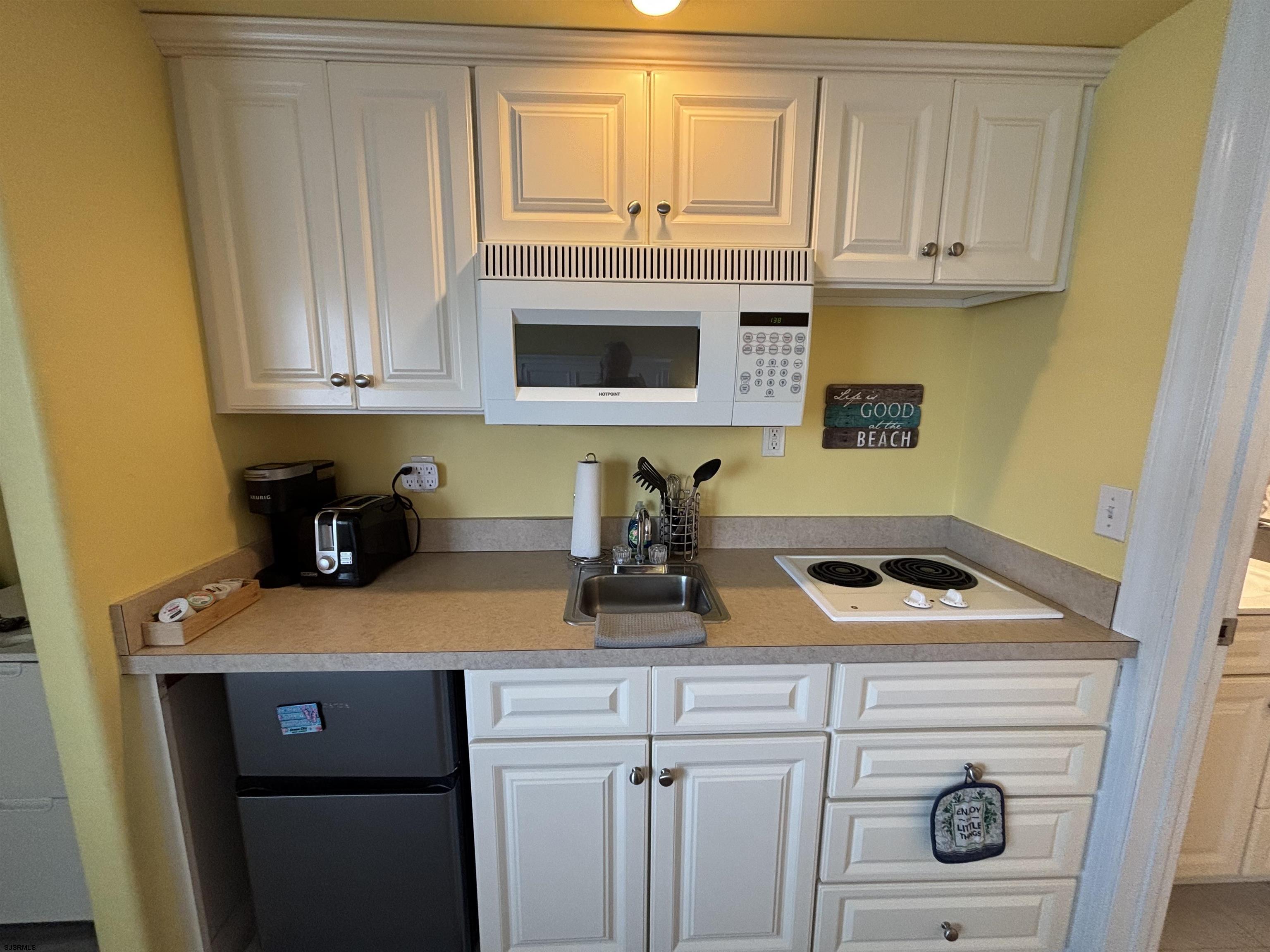 900 Wesley Avenue, Unit 210 Ocean City, NJ 08226 - Photo 12 of 16 a kitchen with a sink and cabinets