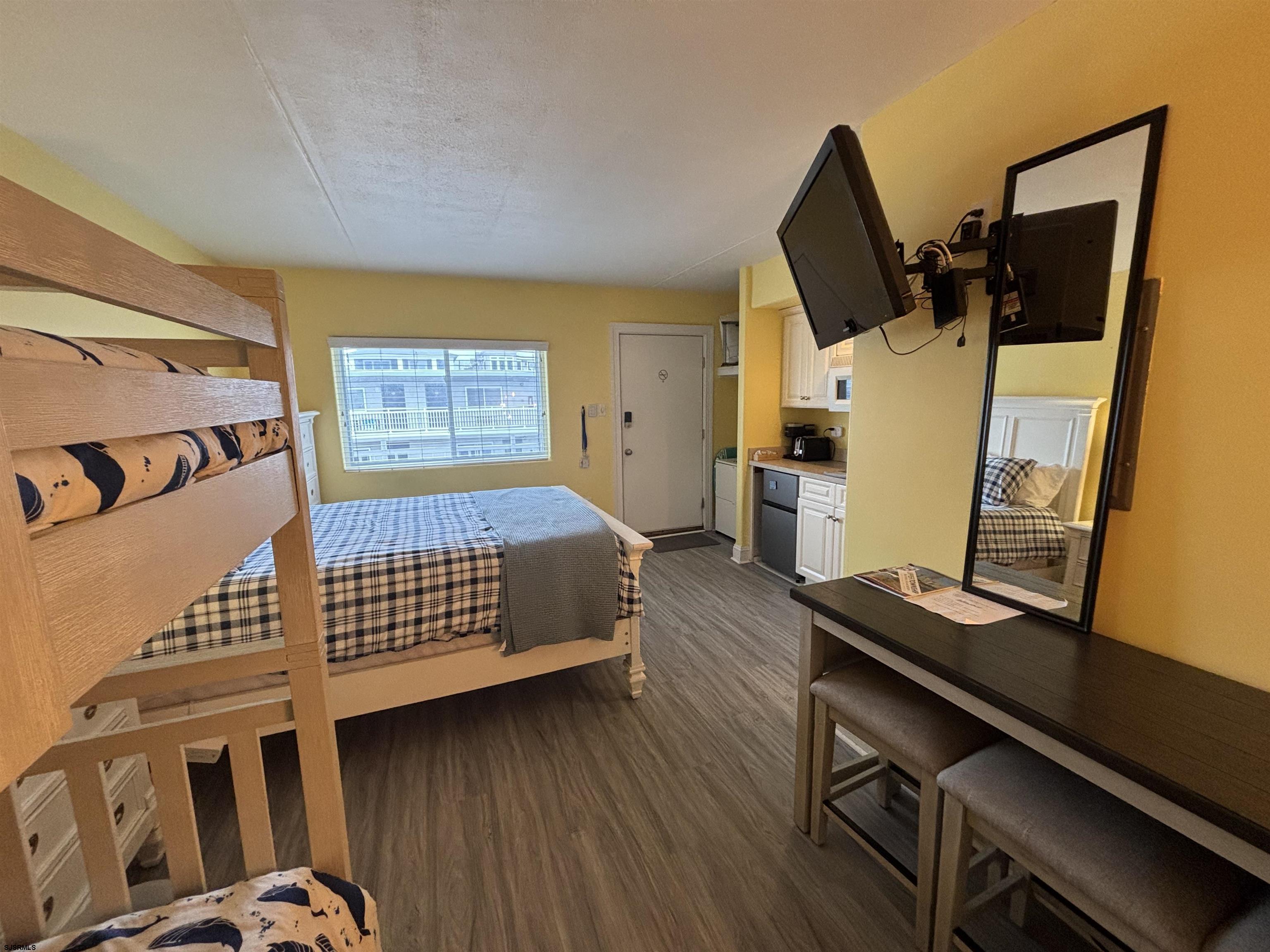 900 Wesley Avenue, Unit 210 Ocean City, NJ 08226 - Photo 14 of 16 a bedroom with furniture and wooden floor