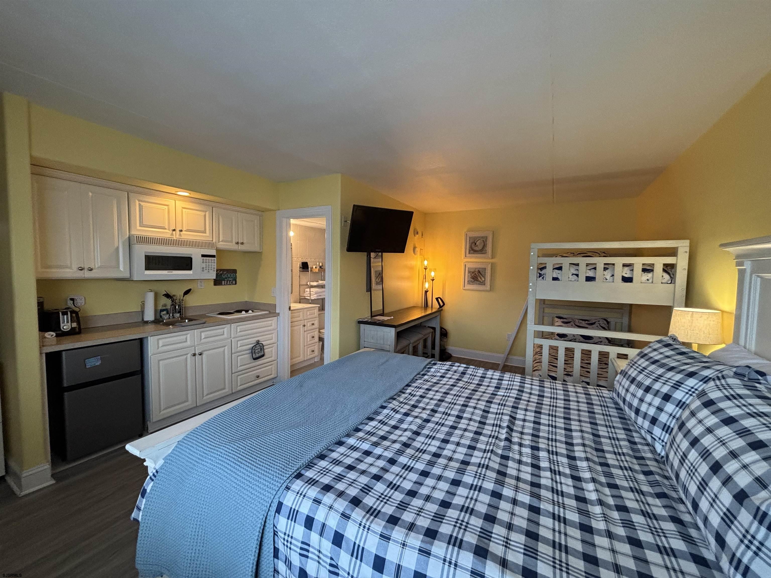 900 Wesley Avenue, Unit 210 Ocean City, NJ 08226 - Photo 8 of 16 a kitchen with a sink a stove top oven and cabinetry