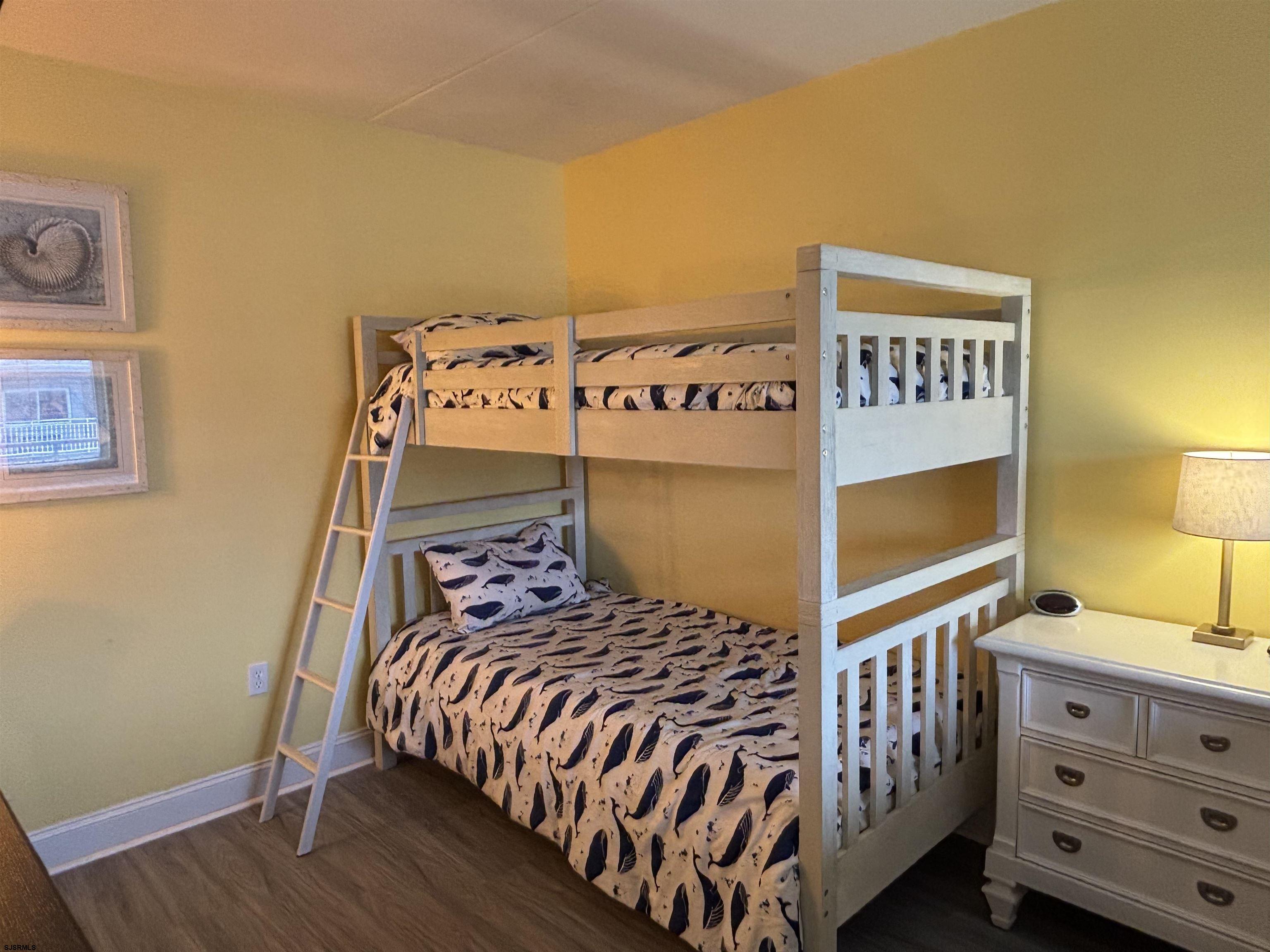 900 Wesley Avenue, Unit 210 Ocean City, NJ 08226 - Photo 10 of 16 a bedroom with a bed and a dresser