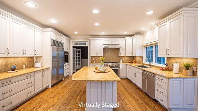a large kitchen with stainless steel appliances granite countertop a stove and a sink