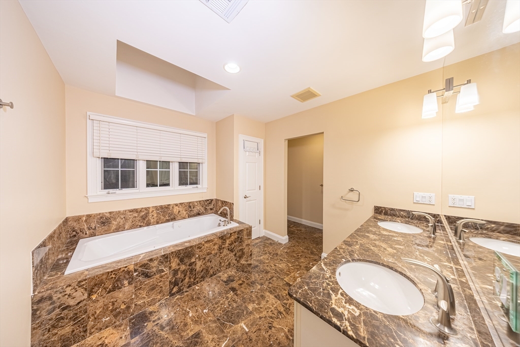 27 Mellon Road Wellesley, MA 02482 - Photo 17 of 42 a bathroom with a granite countertop tub and a sink