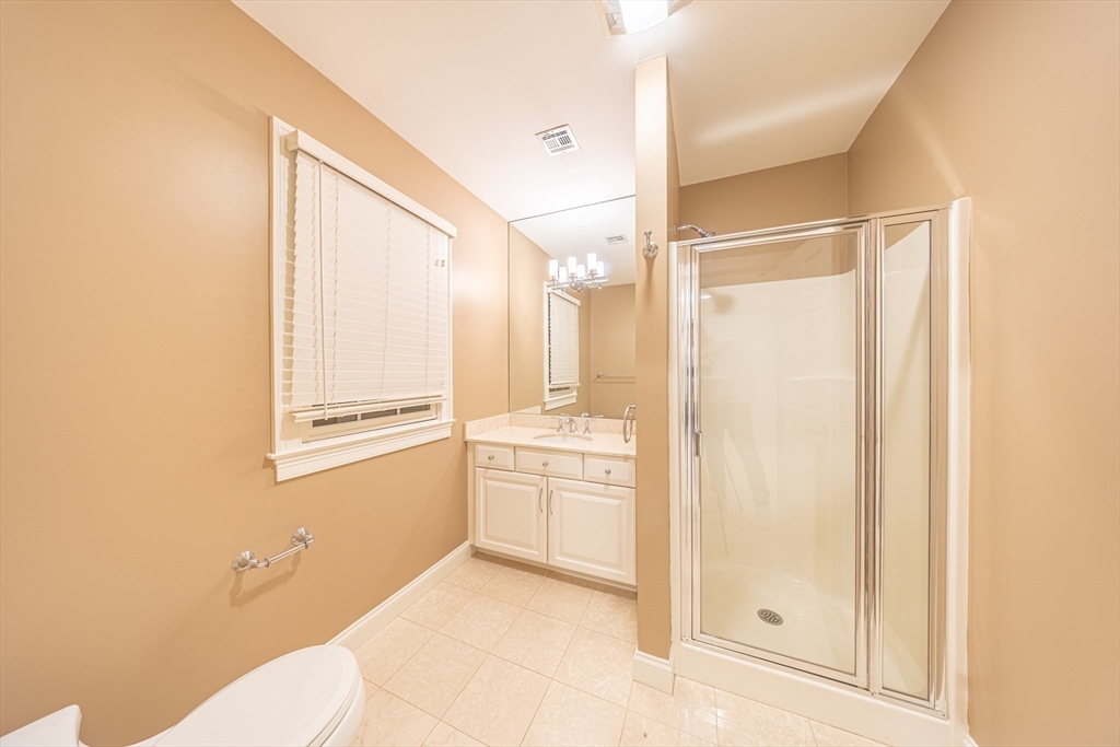 27 Mellon Road Wellesley, MA 02482 - Photo 24 of 42 a bathroom with a granite countertop sink mirror and a shower