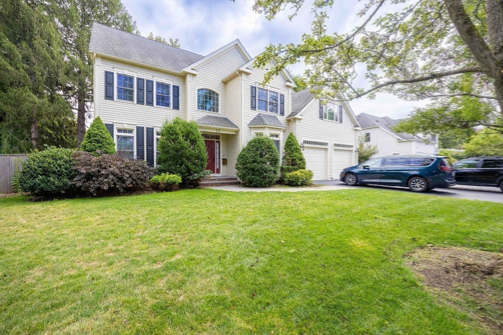 27 Mellon Road Wellesley, MA 02482 - Photo 39 of 42 a front view of a house with a garden and plants