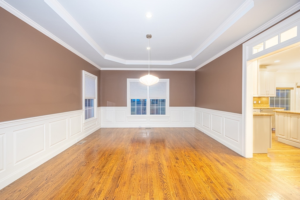 27 Mellon Road Wellesley, MA 02482 - Photo 10 of 42 a view of empty room with wooden floor and fan