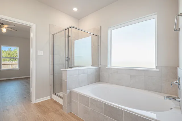 a white bath tub sitting next to a window