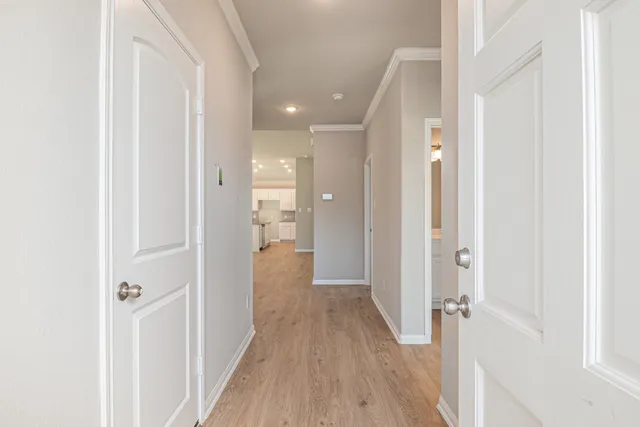 a view of a hallway with wooden floor