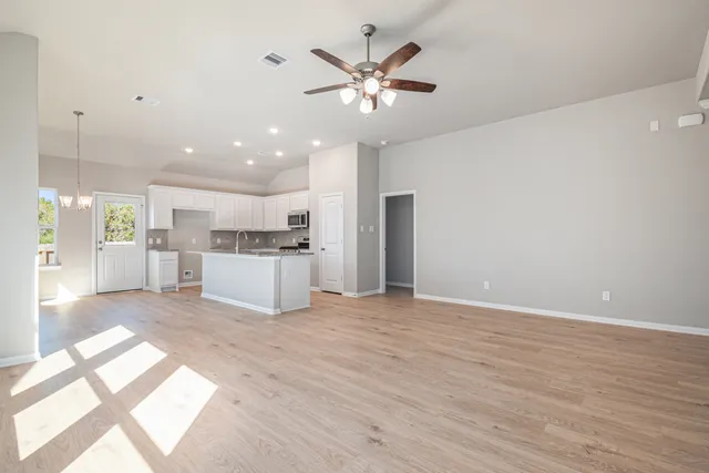 a view of a kitchen with a sink and a window