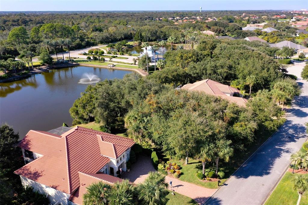 8 Flagship Drive Palm Coast, FL 32137 - Photo 10 of 31 an aerial view of a house with a garden and lake view