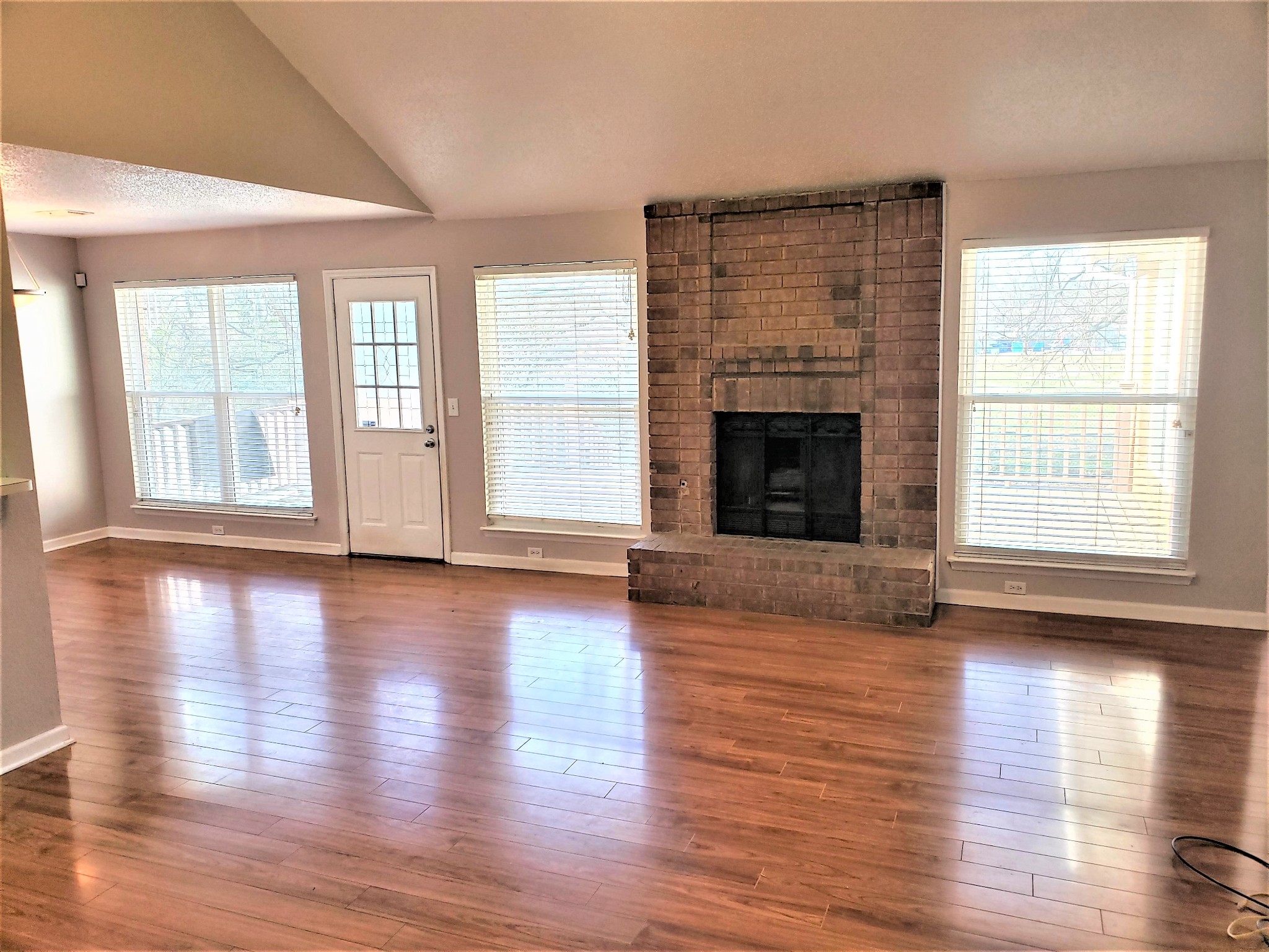 1737 Ridgemere Court Hermitage, TN 37076 - Photo 2 of 14 an empty room with wooden floor fireplace and windows
