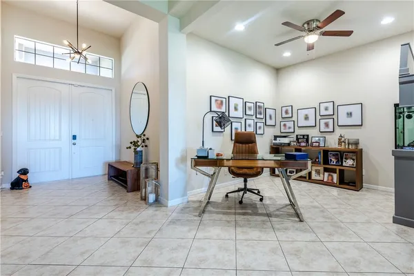a view of a livingroom with workspace and a window